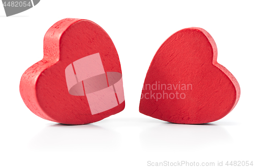 Image of Two red wooden hearts isolated on white