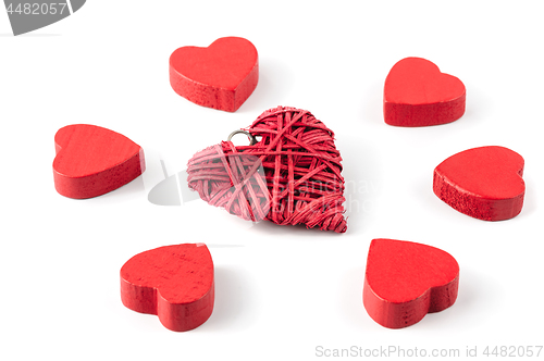 Image of Group or red hearts isolated on white, six wooden and one strawy