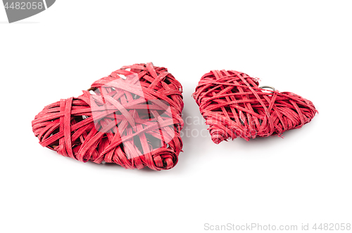 Image of Two red hearts made of straw, isolated on white