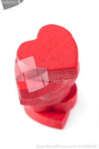 Image of Stack of red wooden hearts, isolated on white