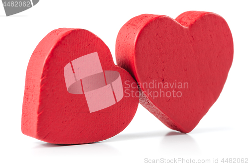 Image of Two red wooden hearts isolated on white