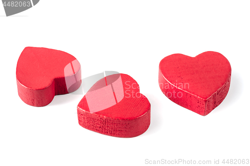 Image of Three red wooden hearts isolated on white