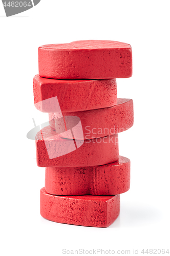 Image of Stack of red wooden hearts, isolated on white