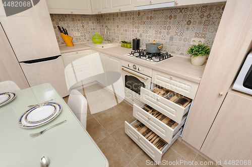 Image of Modern beige colored kitchen and dining room