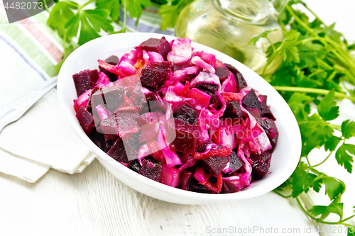 Image of Vinaigrette with cabbage in bowl on board