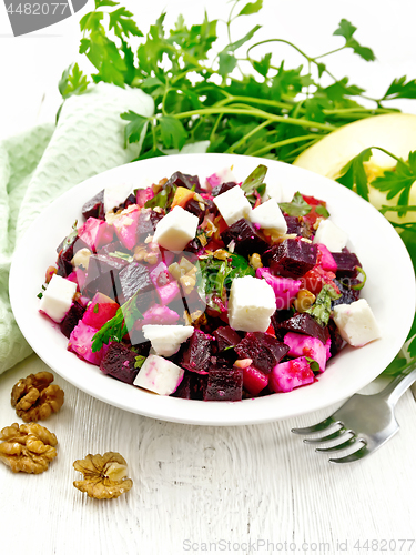 Image of Salad with beetroot and feta in plate on board