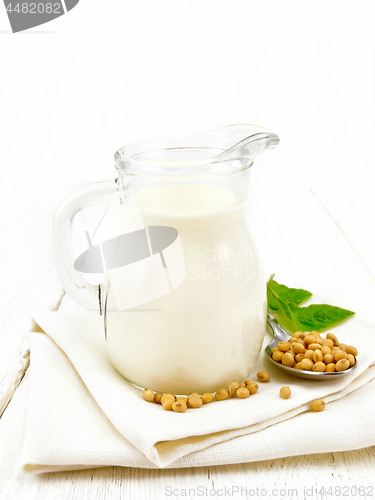 Image of Milk soy in jug with leaf on light board