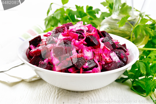 Image of Vinaigrette with cabbage in bowl on light board