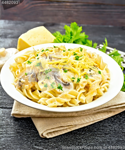 Image of Fusilli with mushrooms on black board