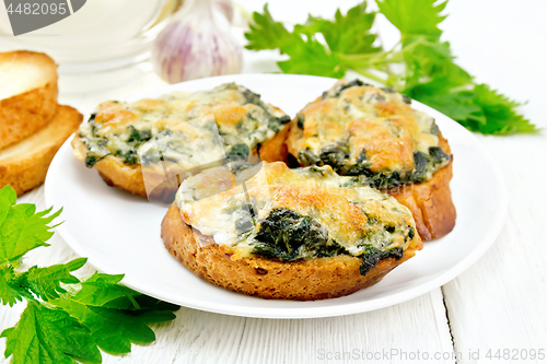 Image of Sandwich of nettle and cheese in plate on white board