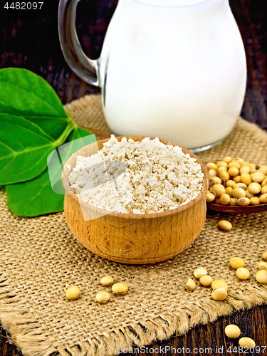 Image of Flour soy in bowl with soybean and leaf on board