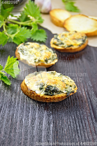 Image of Sandwich of nettle on dark wooden board