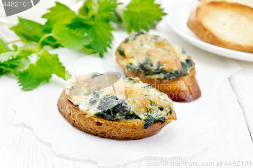 Image of Sandwich of nettle and cheese on board