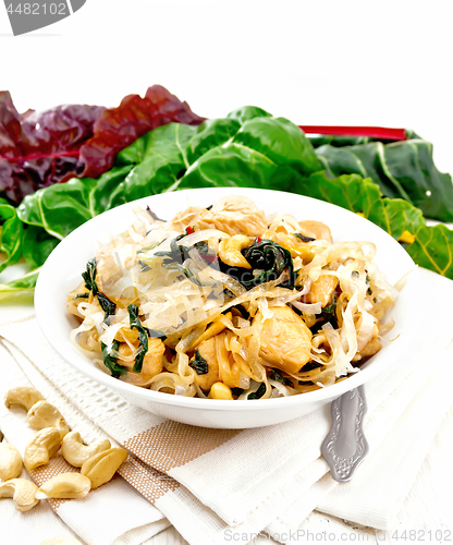 Image of Funchoza with chard and cashew in bowl on board