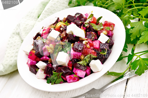 Image of Salad with beetroot and feta in plate on table