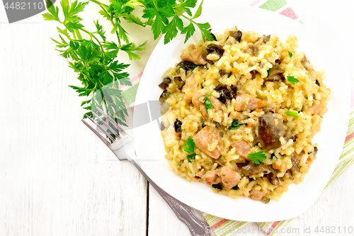 Image of Risotto with mushrooms and chicken on light board top