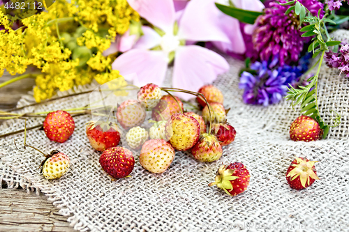 Image of Strawberries with flowers on burlap