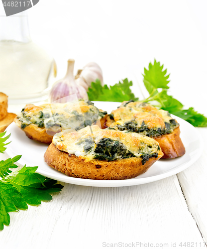 Image of Sandwich of nettle and cheese in plate on board