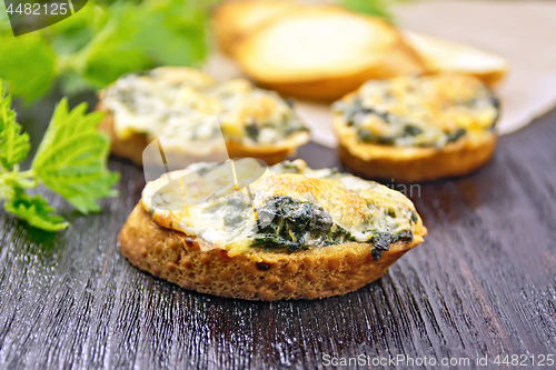 Image of Sandwich of nettle and cheese on dark board