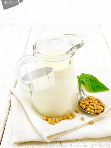 Image of Milk soy in jug with leaf on board