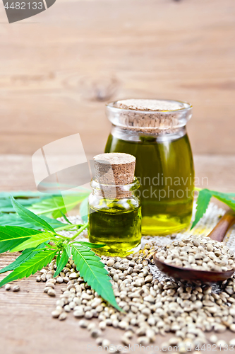 Image of Oil hemp in two jars on old board