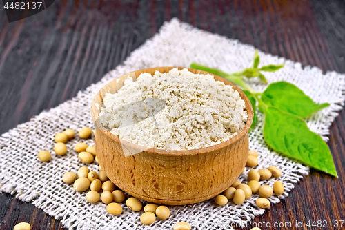 Image of Flour soy in bowl with leaf on dark board