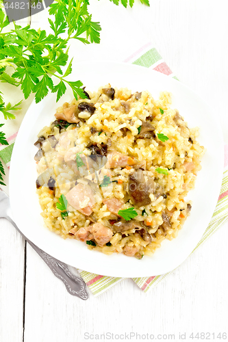 Image of Risotto with mushrooms and chicken on wooden board top