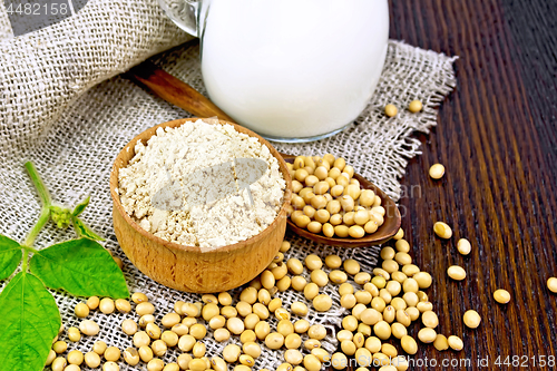 Image of Flour soy in bowl with soybeans and milk on board