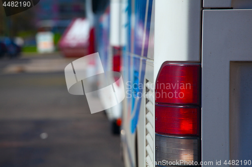 Image of back view of bus, red side lamp