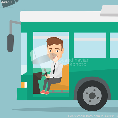 Image of Caucasian bus driver sitting at steering wheel.