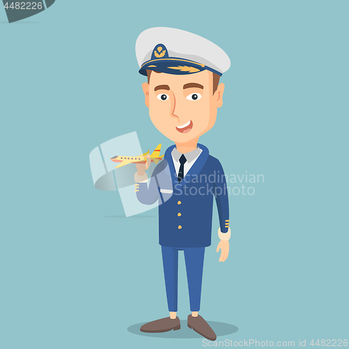 Image of Cheerful airline pilot with model of airplane.