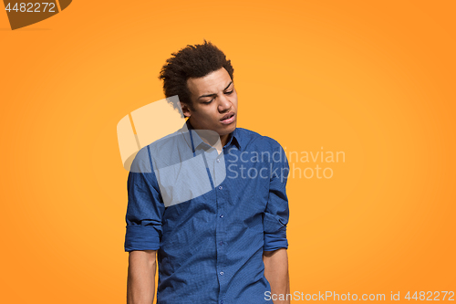 Image of Beautiful bored man bored isolated on orange background