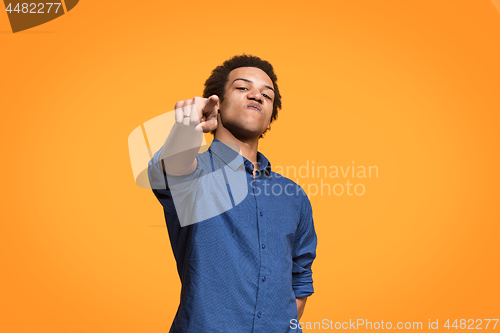 Image of The overbearing businessman point you and want you, half length closeup portrait on orange background.