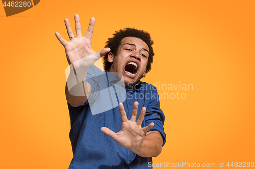 Image of Portrait of the scared man on orange