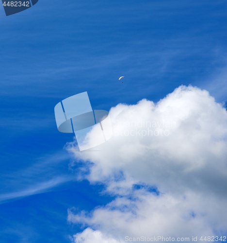 Image of Cloud and Man on Parachute Wing
