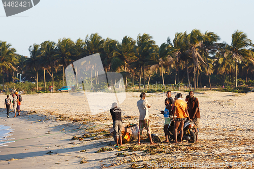 Image of Malagasy peoples resting on the beach in harbor