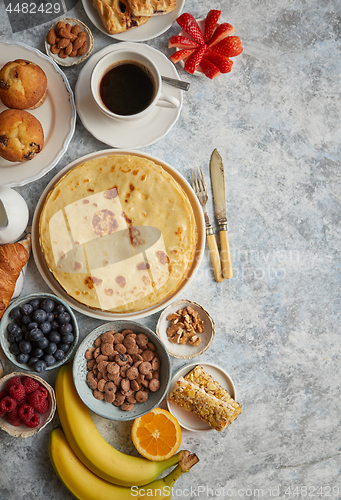 Image of Various breakfast ingredients placed on stone table