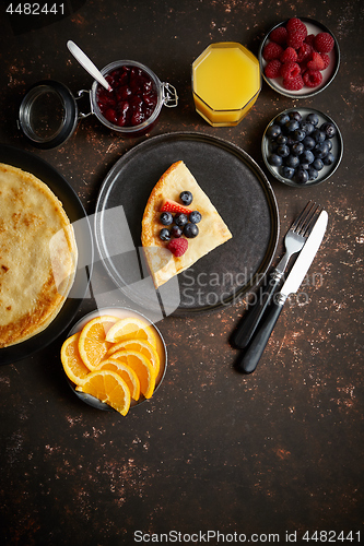 Image of Tasety homemade pancake on black ceramic plate.