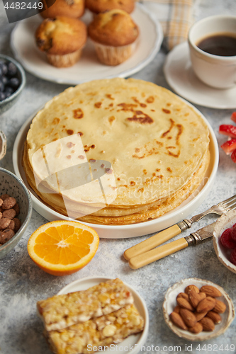 Image of Various breakfast ingredients placed on stone table