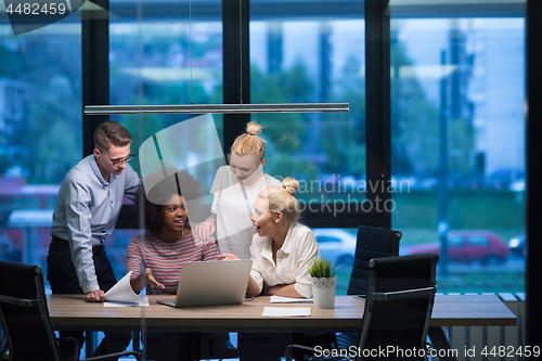 Image of Multiethnic startup business team in night office