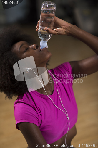 Image of young afro american woman in gym have pilates workout break