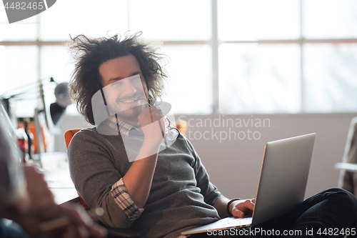 Image of businessman working using a laptop in startup office