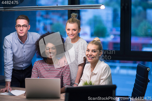 Image of Multiethnic startup business team in night office