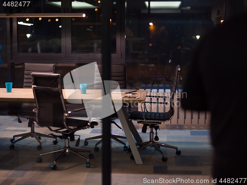 Image of man working on laptop in dark office