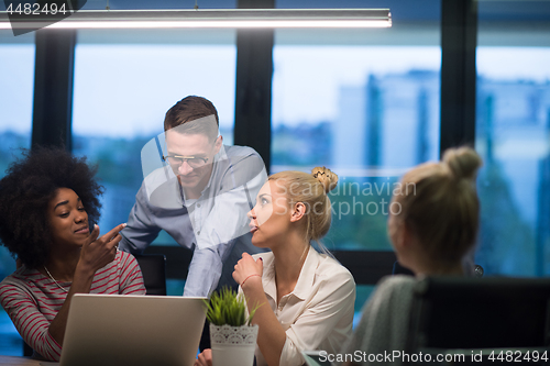 Image of Multiethnic startup business team in night office