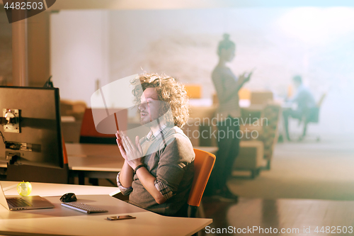 Image of businessman relaxing at the desk