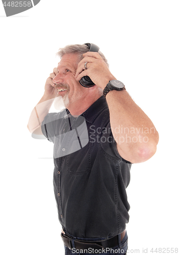 Image of Middle age man having fun listening to music