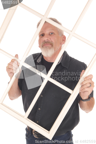 Image of Middle age man holding window frame