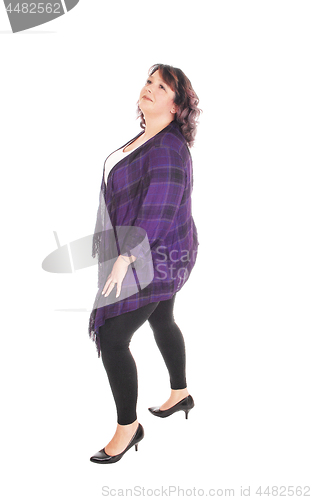 Image of Full figured woman standing in profile