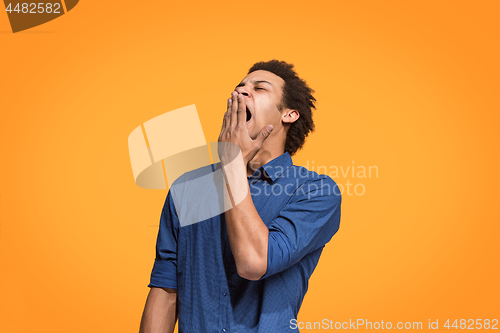 Image of Beautiful bored man bored isolated on orange background